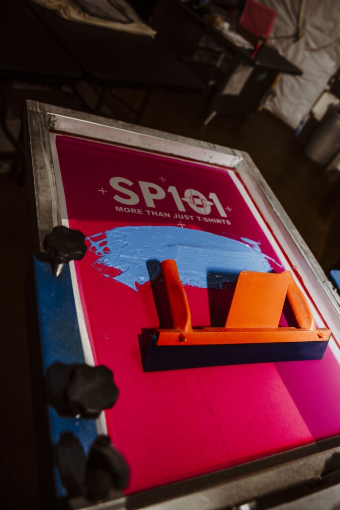 Screen printing setup featuring a pink stencil with "SP101"